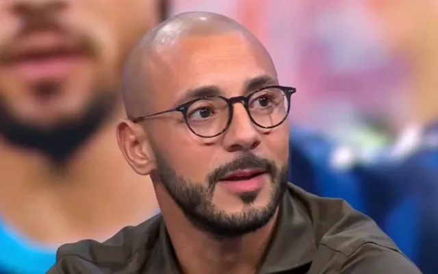 Portrait de Nordin Amrabat portant des lunettes lors d’un entretien télévisé